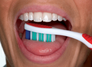 how to clean your tongue with a toothbrush